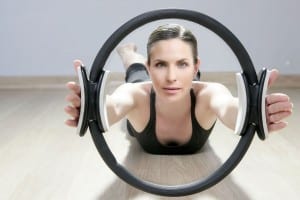 Women uses the Magic Circle to achieve a balanced body